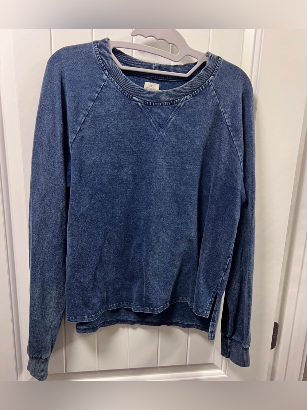 Ladies size medium/ large- O'Neill blue sweatshirt/ faded wash/ crew neck